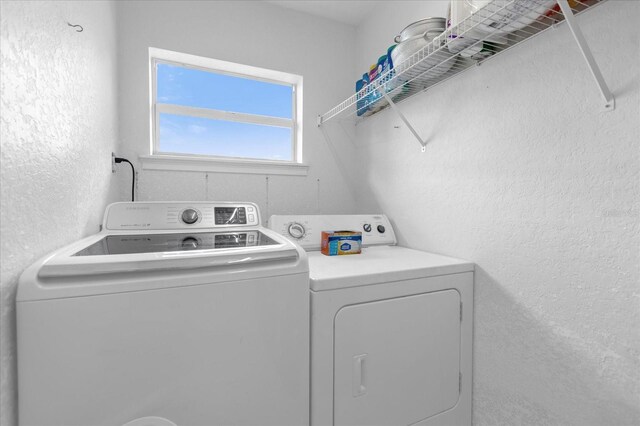 laundry area featuring washing machine and clothes dryer