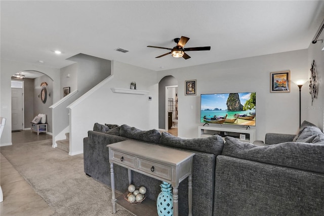 tiled living room with ceiling fan