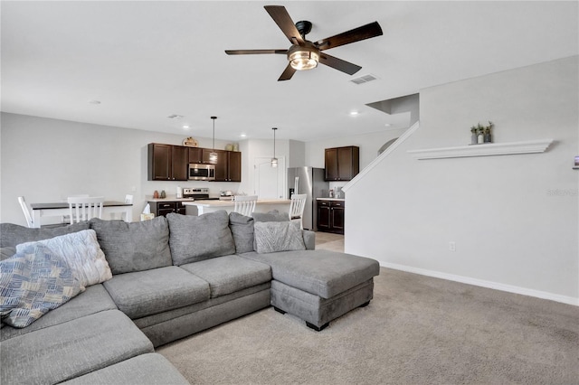 carpeted living room featuring ceiling fan