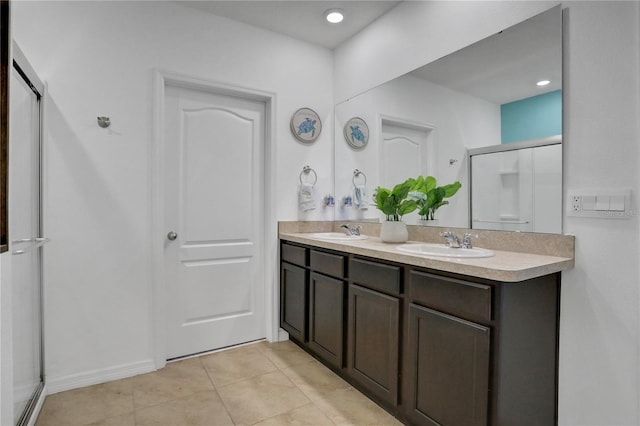 bathroom featuring vanity, tile patterned floors, and walk in shower