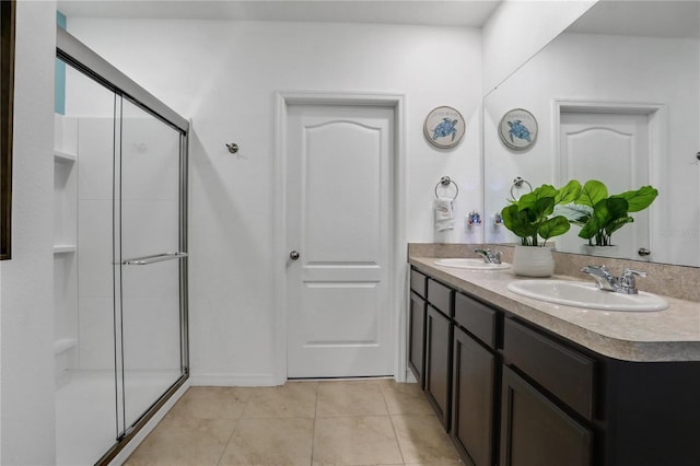 bathroom with vanity, walk in shower, and tile patterned floors