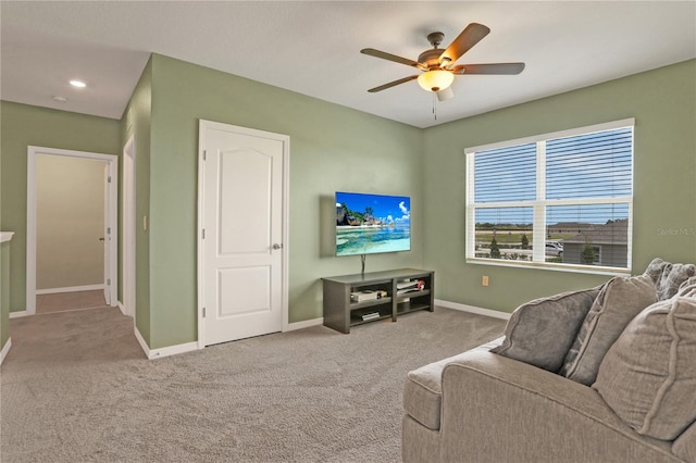 carpeted living room featuring ceiling fan