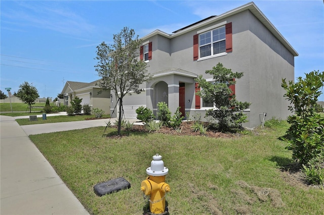 mediterranean / spanish-style house with a garage and a front yard