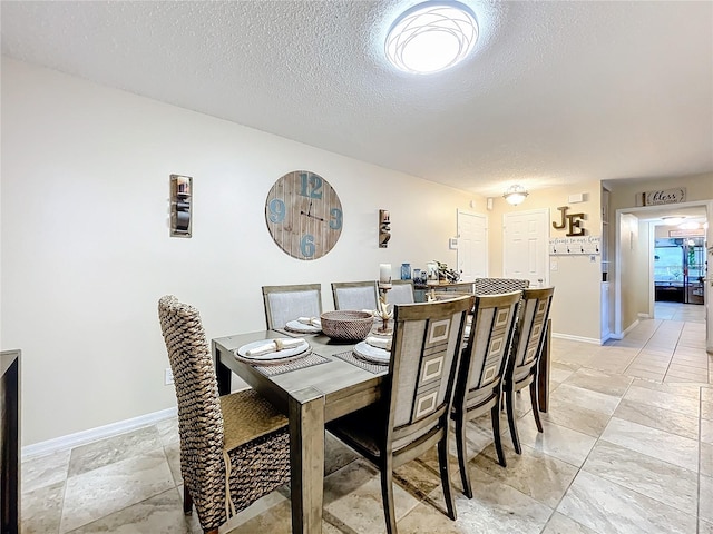 dining room featuring a textured ceiling