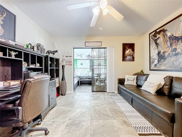 office with a textured ceiling and ceiling fan