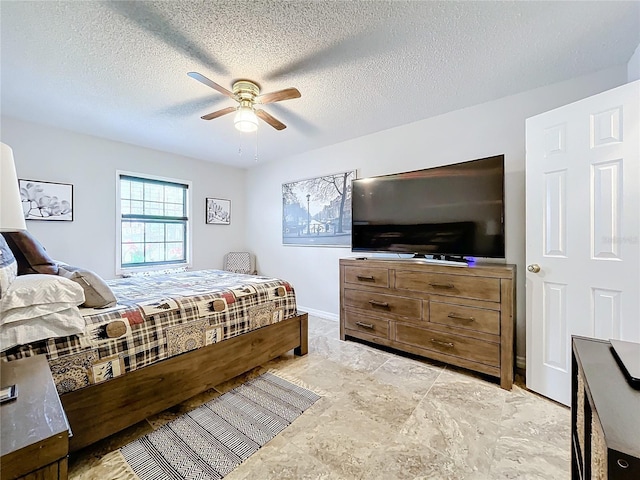 bedroom with a textured ceiling and ceiling fan