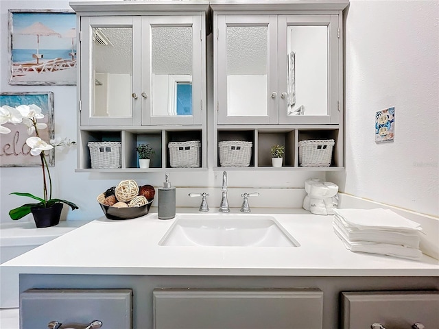 bar featuring gray cabinets and sink