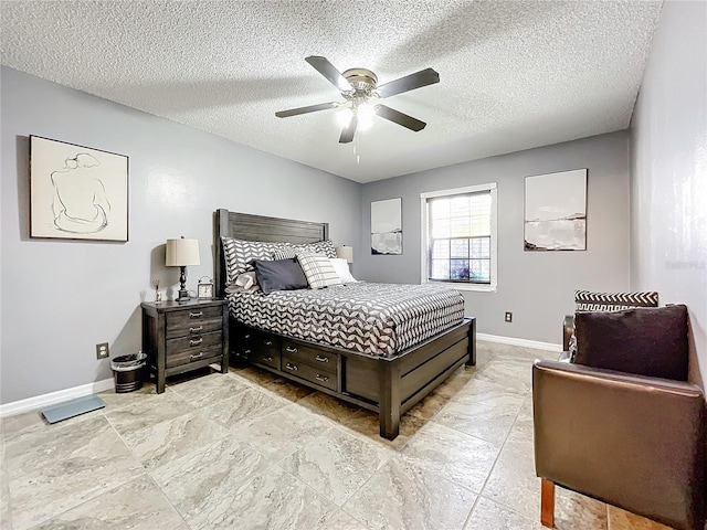 bedroom featuring ceiling fan and a textured ceiling