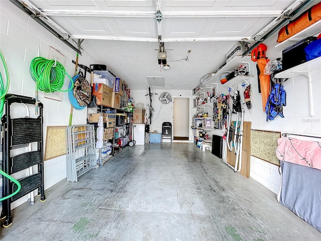 garage with a garage door opener and a workshop area