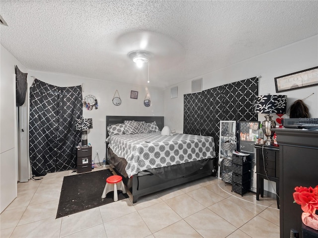 bedroom featuring a textured ceiling, light tile patterned flooring, and ceiling fan