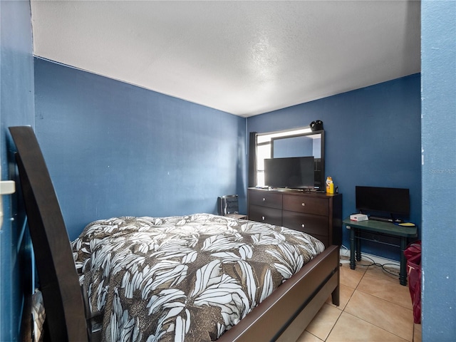 tiled bedroom featuring a textured ceiling