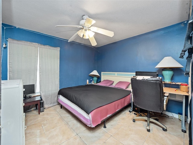 tiled bedroom featuring a textured ceiling and ceiling fan