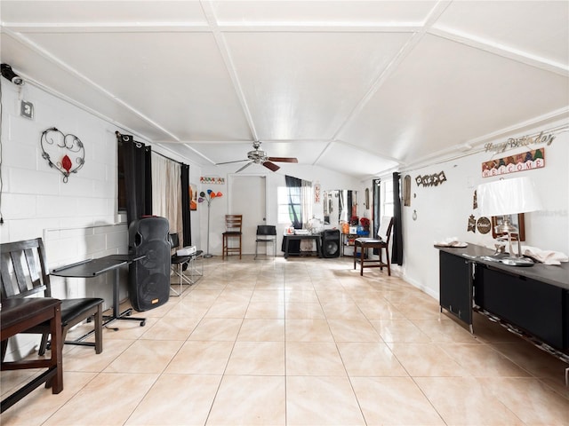 interior space featuring lofted ceiling, ceiling fan, and light tile patterned floors