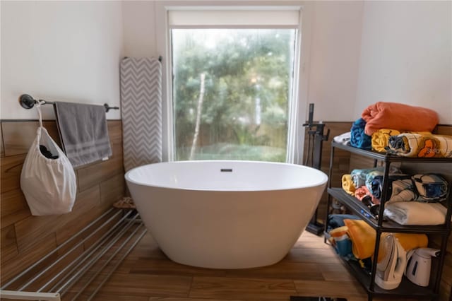 bathroom featuring hardwood / wood-style floors and a bath