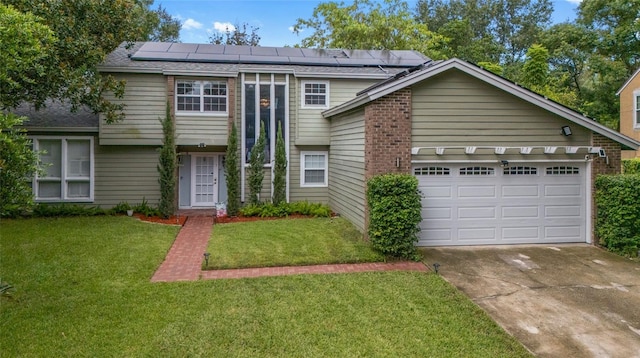 view of front of home featuring a front lawn, a garage, and solar panels