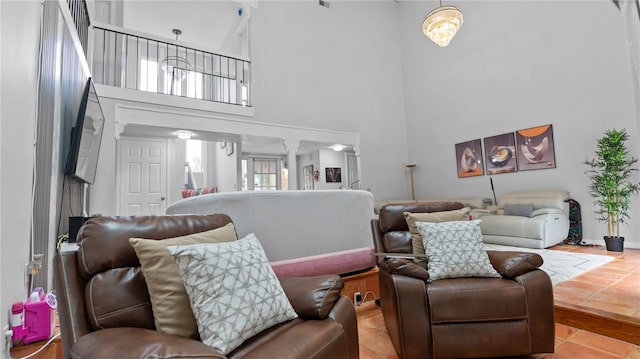 tiled living room featuring a towering ceiling