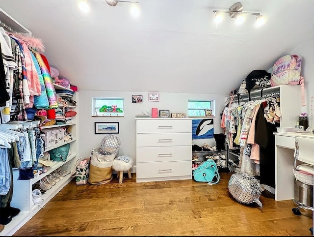 spacious closet featuring lofted ceiling and light hardwood / wood-style floors