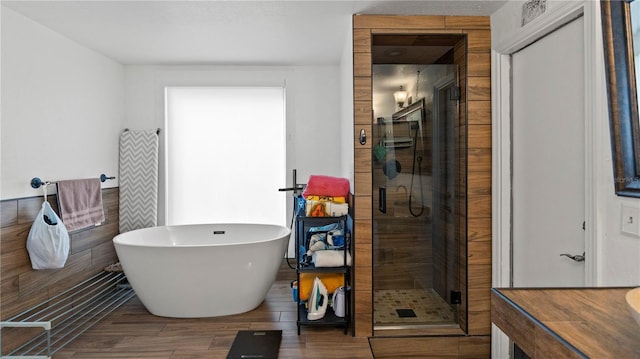 bathroom with shower with separate bathtub, hardwood / wood-style floors, and vanity