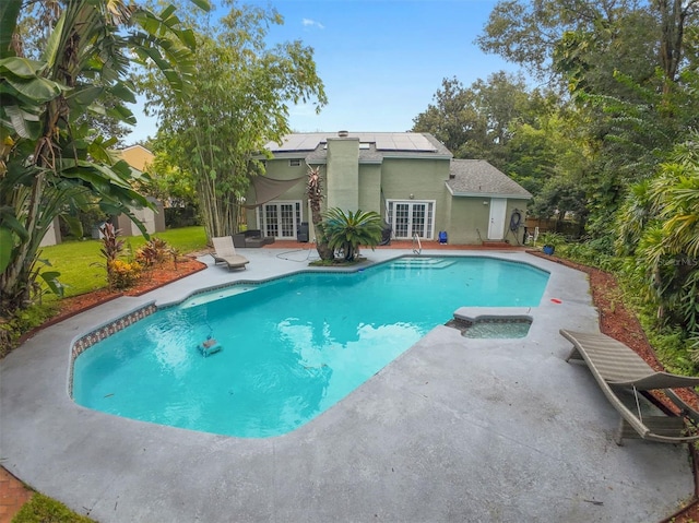 view of swimming pool with a patio area and french doors