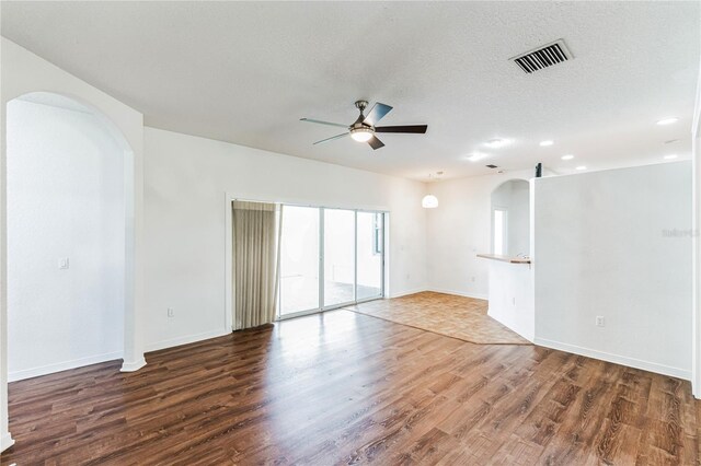 unfurnished room with ceiling fan, a textured ceiling, and hardwood / wood-style floors