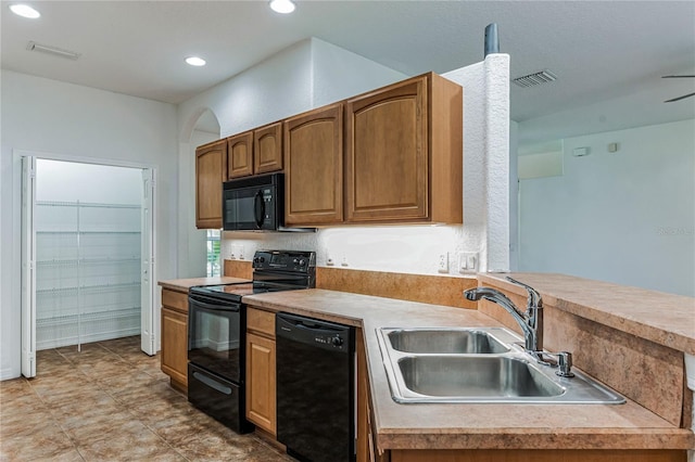 kitchen with light tile patterned floors, sink, and black appliances