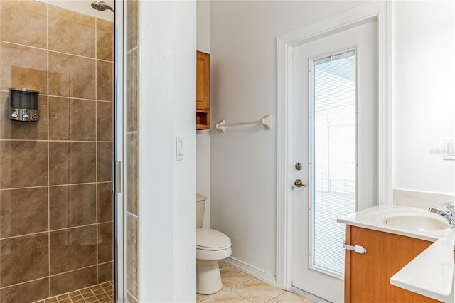 full bathroom featuring a stall shower, tile patterned flooring, vanity, and toilet