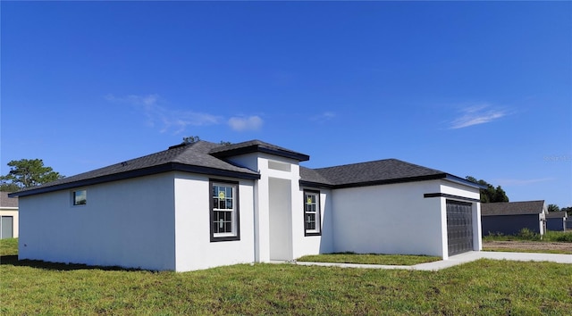 view of front of house with a garage and a front yard