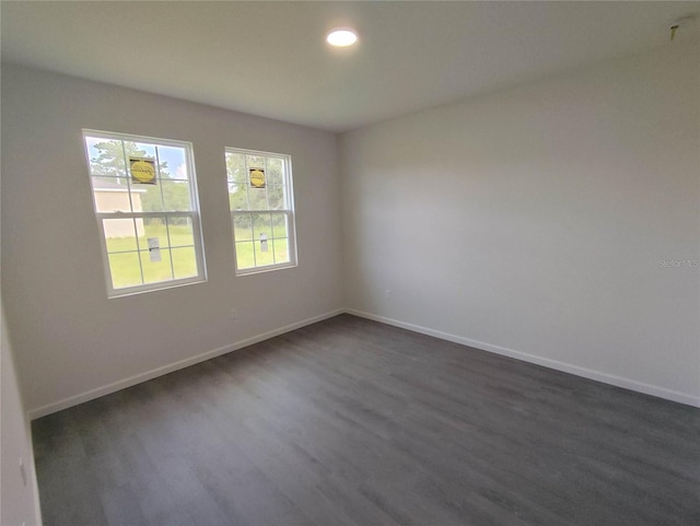 unfurnished room featuring dark wood-type flooring