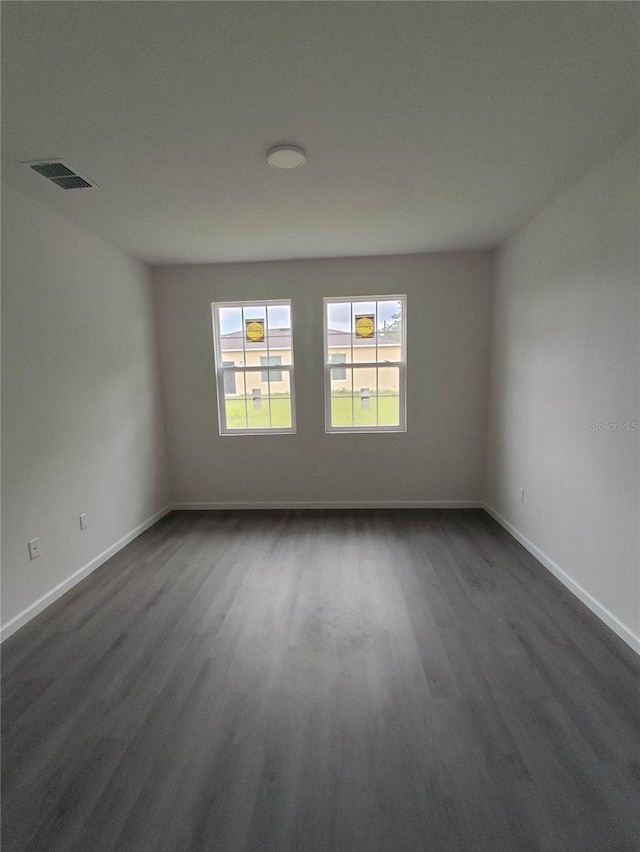 empty room featuring dark hardwood / wood-style flooring