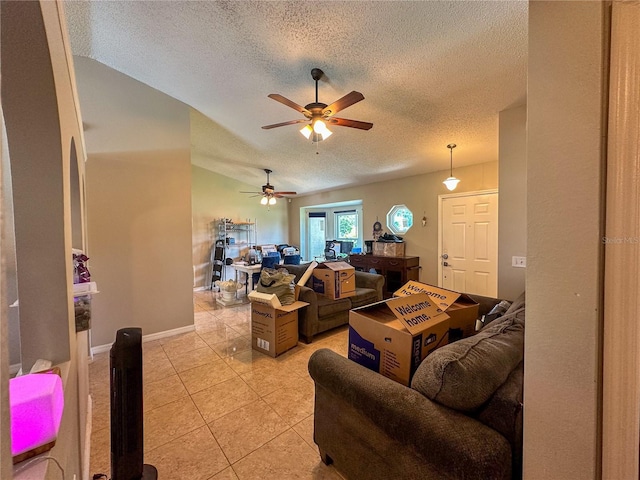 living room featuring a textured ceiling, ceiling fan, light tile patterned flooring, and lofted ceiling