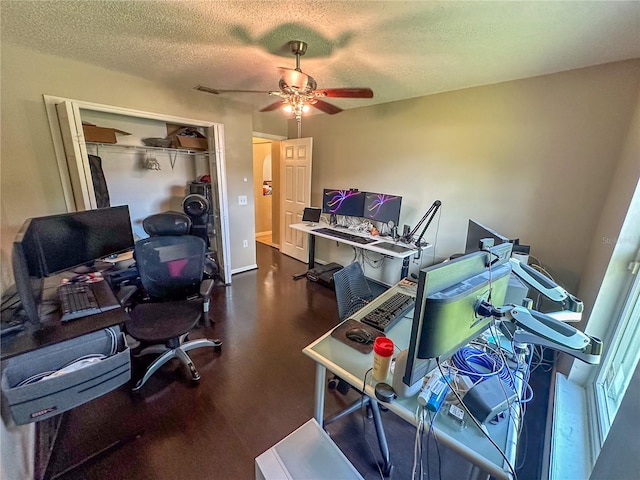 office with ceiling fan and a textured ceiling