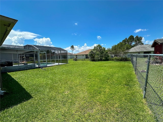 view of yard featuring glass enclosure and a fenced in pool