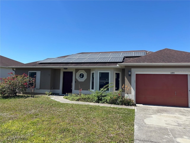 ranch-style house featuring stucco siding, a front lawn, concrete driveway, an attached garage, and solar panels