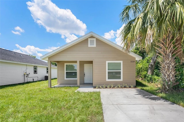 bungalow-style house with central AC and a front yard