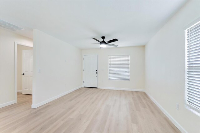 spare room featuring ceiling fan and light hardwood / wood-style floors