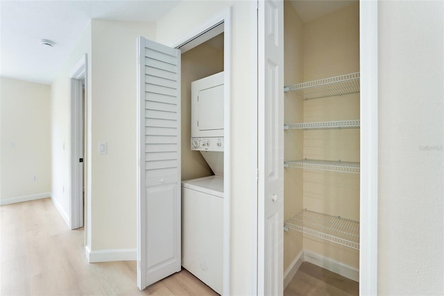 interior space featuring light hardwood / wood-style floors and stacked washer / dryer