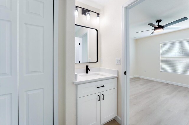 bathroom featuring hardwood / wood-style flooring, vanity, and ceiling fan