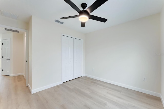 unfurnished bedroom with a closet, ceiling fan, and light hardwood / wood-style flooring