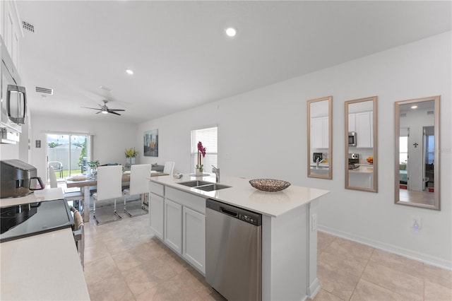 kitchen featuring stainless steel appliances, an island with sink, ceiling fan, sink, and white cabinetry