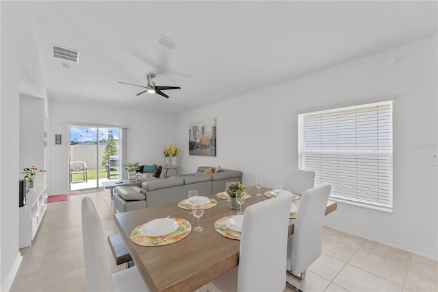 dining space with ceiling fan and light tile patterned floors