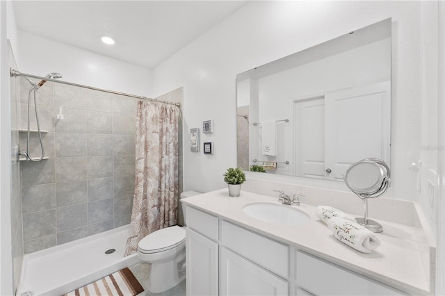 bathroom with vanity, walk in shower, and toilet