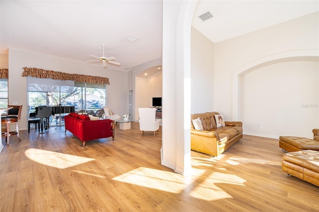 living room with hardwood / wood-style flooring and ceiling fan