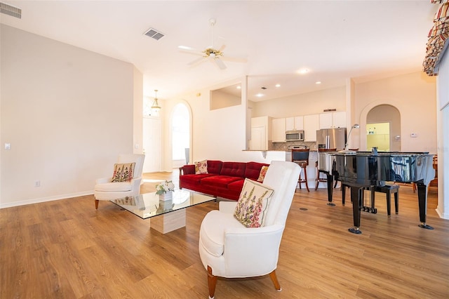 living room featuring light hardwood / wood-style floors and ceiling fan