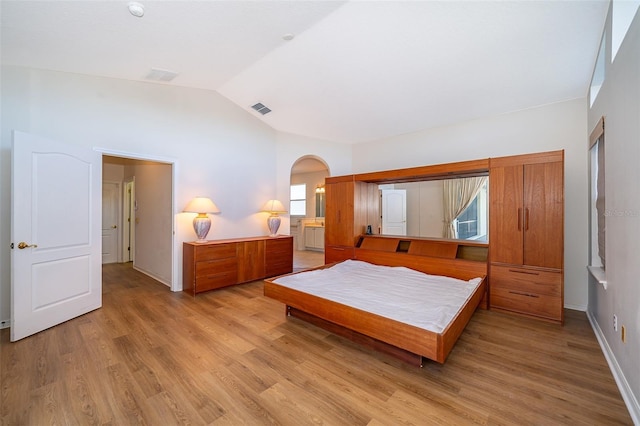 bedroom featuring vaulted ceiling and light hardwood / wood-style floors