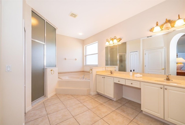 bathroom with vanity, independent shower and bath, and tile patterned flooring