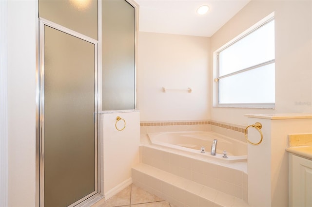 bathroom with tile patterned floors, independent shower and bath, and vanity