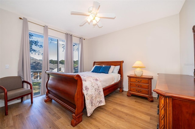 bedroom with access to exterior, light hardwood / wood-style flooring, and ceiling fan