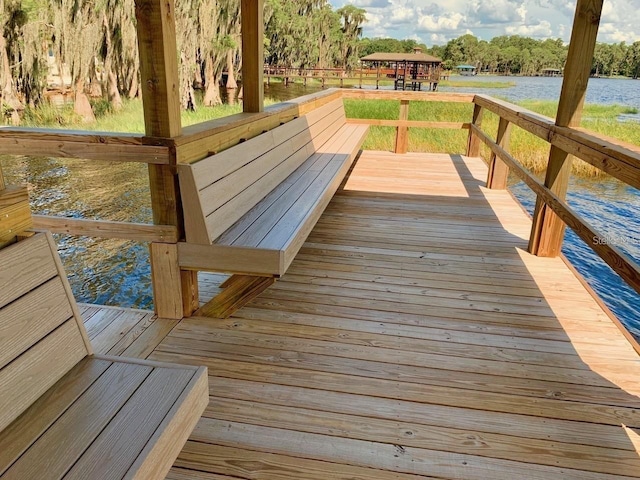 wooden terrace featuring a water view