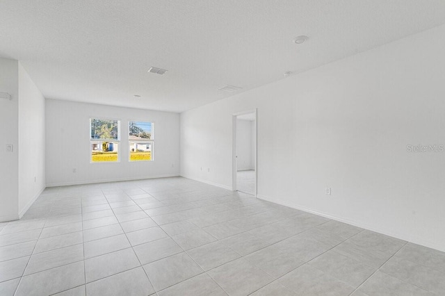 349 River Front Way, Edgewater, FL 32141 - tiled spare room featuring a textured ceiling