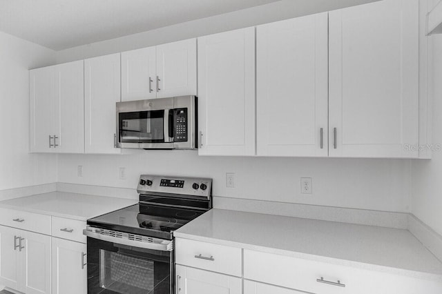 349 River Front Way, Edgewater, FL 32141 - kitchen featuring appliances with stainless steel finishes and white cabinets